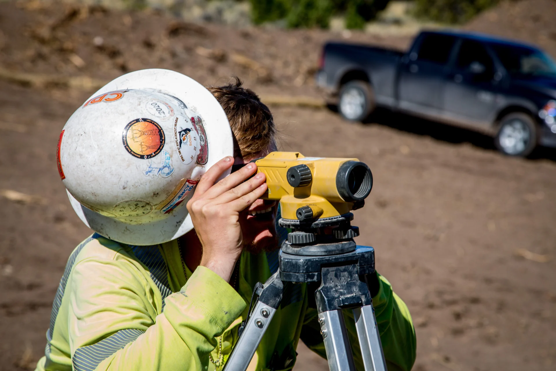 Cassidy field crew member checking alignment with an optical instrument.