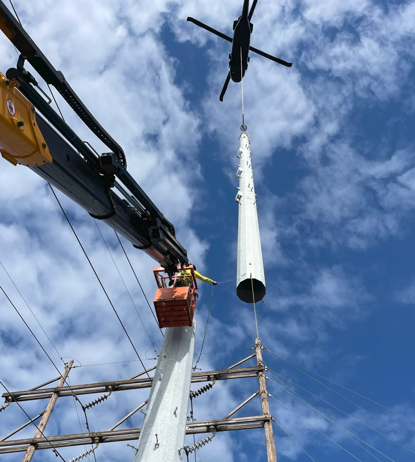 Helicopter-assisted pole installation.