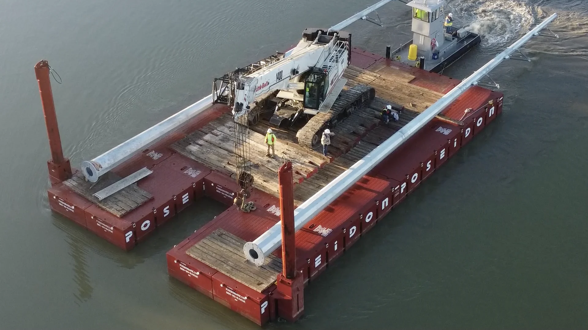Crane and transmission poles transported on a modular barge.