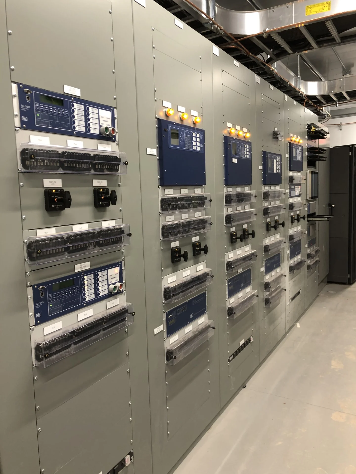 Protective relays and control panels inside a substation control house.