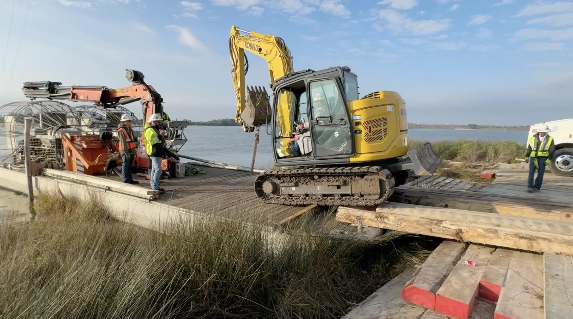 Crew and equipment working at the water’s edge